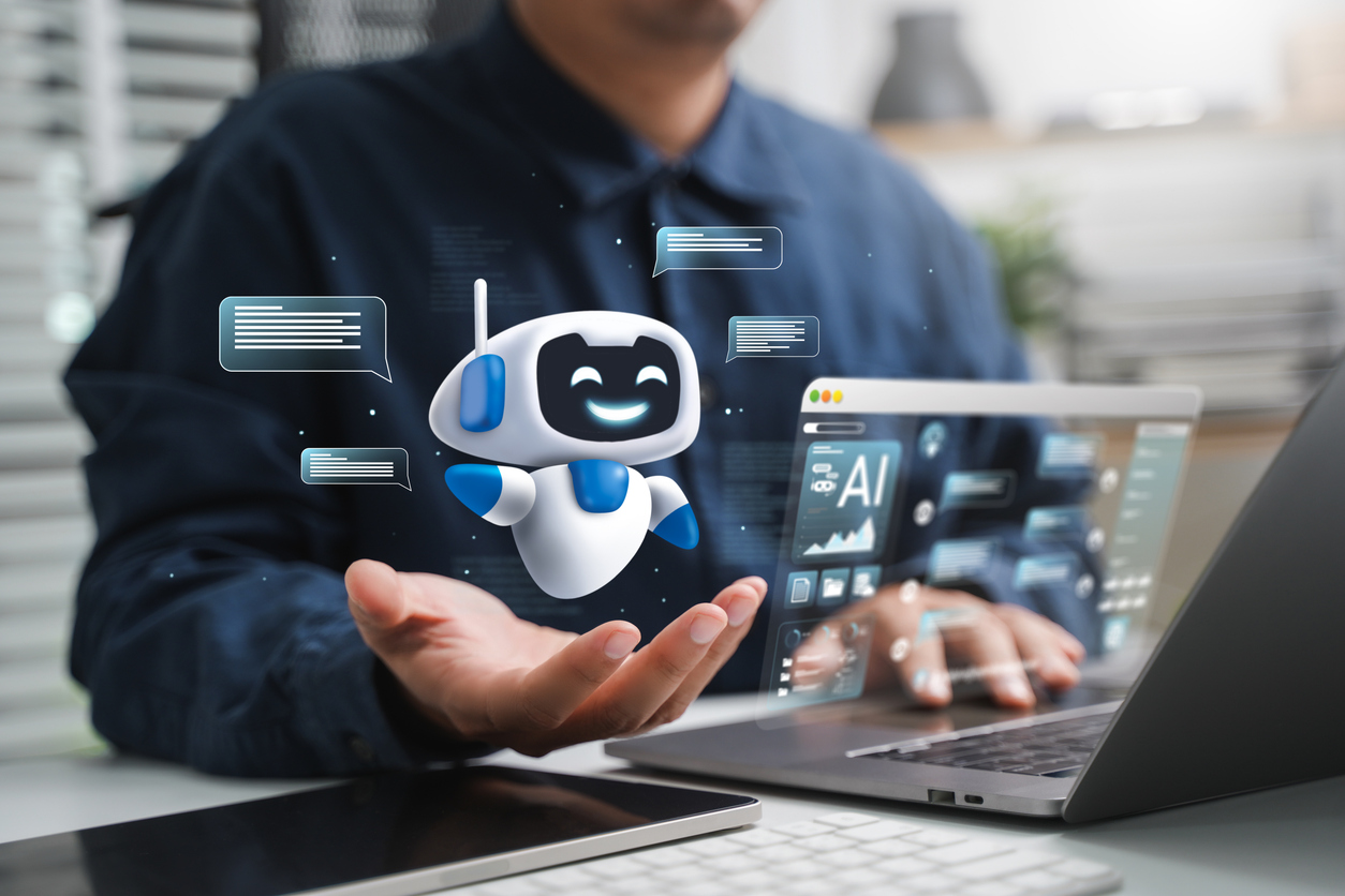 man achter laptop met concept ai in zijn hand